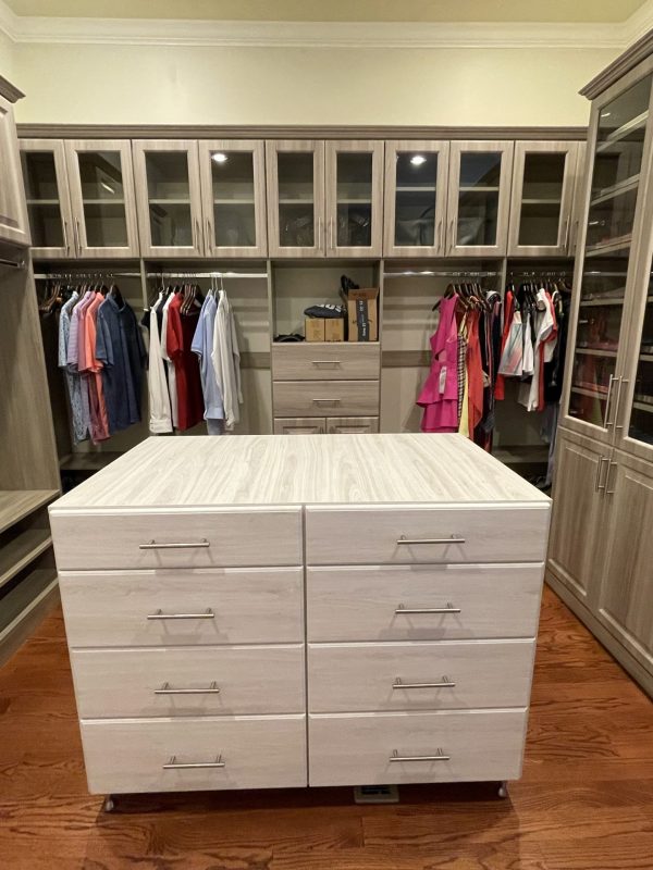 A walk-in closet with drawers and cabinets, perfect for organizing clothes and accessories.